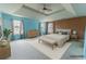 Spacious primary bedroom boasts a tray ceiling, three large windows, and ample space for a sitting area at 366 Highbranch Cir, Lawrenceville, GA 30044