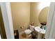 Well-lit powder room featuring a pedestal sink, toilet, and neutral decor at 366 Highbranch Cir, Lawrenceville, GA 30044