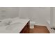Bathroom with dark wood cabinets, white countertops, and wood style flooring at 10814 Wheeler Trce, Hampton, GA 30228