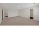 A carpeted bedroom with doors leading to the ensuite and laundry area at 10814 Wheeler Trce, Hampton, GA 30228