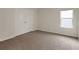 A cozy bedroom with neutral walls, plush carpet, and double door closet at 10814 Wheeler Trce, Hampton, GA 30228