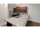 The kitchen features granite counters, stainless appliances, a breakfast bar and dark wood cabinets at 10814 Wheeler Trce, Hampton, GA 30228