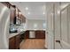 The modern kitchen features granite counters, stainless appliances, tile backsplash, and wood floors at 10814 Wheeler Trce, Hampton, GA 30228