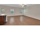 The living room features wood floors, a ceiling fan, two windows and bar access to the kitchen at 10814 Wheeler Trce, Hampton, GA 30228