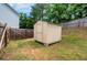 A small storage shed located in the backyard with a well manicured lawn at 10814 Wheeler Trce, Hampton, GA 30228