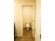 Bathroom featuring granite countertop, dark cabinets, vinyl floors and a toilet at 1612 Fuma Leaf Way, Mcdonough, GA 30253