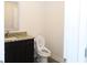 Bathroom featuring dark cabinets, a granite countertop, and a sleek, modern toilet at 1612 Fuma Leaf Way, Mcdonough, GA 30253