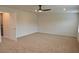 Spacious carpeted bedroom features a ceiling fan and bright neutral walls at 1612 Fuma Leaf Way, Mcdonough, GA 30253