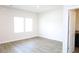 Bright bedroom featuring wood-look flooring and natural light at 1612 Fuma Leaf Way, Mcdonough, GA 30253