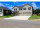 Charming two-story home with a three-car garage, a well-maintained lawn and blue sky at 1612 Fuma Leaf Way, Mcdonough, GA 30253