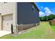 View of home's vinyl siding and brick foundation; green lawn is well maintained at 1612 Fuma Leaf Way, Mcdonough, GA 30253