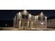 Well lit two-story home at night featuring a two-car garage and a brick exterior at 1612 Fuma Leaf Way, Mcdonough, GA 30253