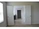 Hallway with plank floors leads to a room with black vanity and granite countertop at 1612 Fuma Leaf Way, Mcdonough, GA 30253