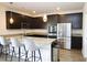 Modern kitchen with granite countertops, stainless steel appliances, and a breakfast bar at 1612 Fuma Leaf Way, Mcdonough, GA 30253
