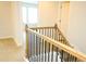 Upstairs landing showcasing a wooden railing with black iron spindles at 1612 Fuma Leaf Way, Mcdonough, GA 30253