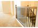 Upper level landing featuring carpet flooring and decorative wood and iron railing at 1612 Fuma Leaf Way, Mcdonough, GA 30253