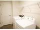 White washing machine and dryer in a laundry room with wood look flooring at 1612 Fuma Leaf Way, Mcdonough, GA 30253