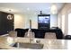 Open-concept kitchen flows into living area, featuring granite countertops and stainless appliances at 1612 Fuma Leaf Way, Mcdonough, GA 30253