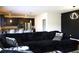 Comfortable living room featuring a large sofa and a modern kitchen in the background at 1612 Fuma Leaf Way, Mcdonough, GA 30253