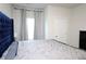 Main bedroom showcasing a luxurious, tufted headboard, large window, and modern decor at 1612 Fuma Leaf Way, Mcdonough, GA 30253