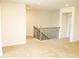 Upstairs hallway with carpet and natural wood railing at 1612 Fuma Leaf Way, Mcdonough, GA 30253