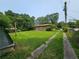 Exterior shot of the home with a long driveway and sheds at 2323 Cedar Terrace Rd, Lithia Springs, GA 30122