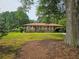 Charming brick home with a well-maintained lawn and covered parking at 2323 Cedar Terrace Rd, Lithia Springs, GA 30122