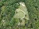 Expansive lot with mature trees offers privacy and a winding drive leading to homes at 891 Wooten Ct, Canton, GA 30114