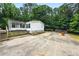 Spacious backyard with concrete patio area and green foliage providing a calm outdoor retreat at 891 Wooten Ct, Canton, GA 30114