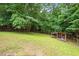 Lush backyard featuring a wooden shelter, perfect for outdoor relaxation at 891 Wooten Ct, Canton, GA 30114