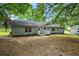 Backyard with a patio and green space, shaded by mature trees at 891 Wooten Ct, Canton, GA 30114