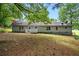 Spacious backyard with a ranch style house and a wooden porch with white railing, perfect for entertaining guests at 891 Wooten Ct, Canton, GA 30114