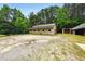 Exterior angle of barn with mature trees and gravel surrounding at 891 Wooten Ct, Canton, GA 30114