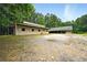 Exterior angle of barn with mature trees and gravel surrounding at 891 Wooten Ct, Canton, GA 30114