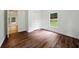 Bedroom featuring hardwood flooring, natural light, and an adjacent doorway at 891 Wooten Ct, Canton, GA 30114