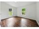 Cozy bedroom with hardwood floors and natural light filtering through two windows at 891 Wooten Ct, Canton, GA 30114