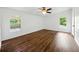 Spacious bedroom with hardwood floors, ceiling fan, and natural light from two windows at 891 Wooten Ct, Canton, GA 30114