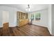 Dining room with hardwood floors, a china cabinet and a view of the wooded backyard at 891 Wooten Ct, Canton, GA 30114