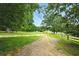 Image shows long driveway lined by trees at 891 Wooten Ct, Canton, GA 30114