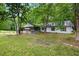 Charming single Gathering home with a covered porch and set back among mature trees at 891 Wooten Ct, Canton, GA 30114
