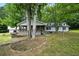 Charming single Gathering home with a covered porch and mature trees in a quiet neighborhood at 891 Wooten Ct, Canton, GA 30114