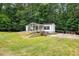 Home featuring terraced front yard, mature trees, screened porch and classic white siding, in private location at 891 Wooten Ct, Canton, GA 30114