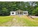 Home featuring terraced front yard, mature trees, screened porch and classic white siding, in private location at 891 Wooten Ct, Canton, GA 30114