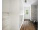Hallway with wood-style flooring and white-washed walls leading to an exterior door at 891 Wooten Ct, Canton, GA 30114
