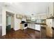 Open kitchen with a black-and-white tiled backsplash, wood-look floors and dark countertops at 891 Wooten Ct, Canton, GA 30114