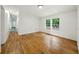 Bright living room featuring hardwood floors and a sun-filled view through large windows at 891 Wooten Ct, Canton, GA 30114
