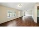 Spacious living room with wood-look flooring, natural light from the exterior and a front door at 891 Wooten Ct, Canton, GA 30114