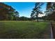 Expansive pasture, enclosed with fencing, offers ample space and scenic views at 891 Wooten Ct, Canton, GA 30114