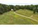Overhead shot of tree-lined acreage with grass and winding drive at 891 Wooten Ct, Canton, GA 30114