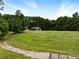 Expansive view of lawn and trees featuring buildings at 891 Wooten Ct, Canton, GA 30114